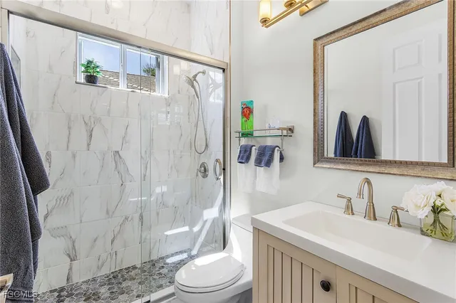 a bedroom with a bed window and a desk