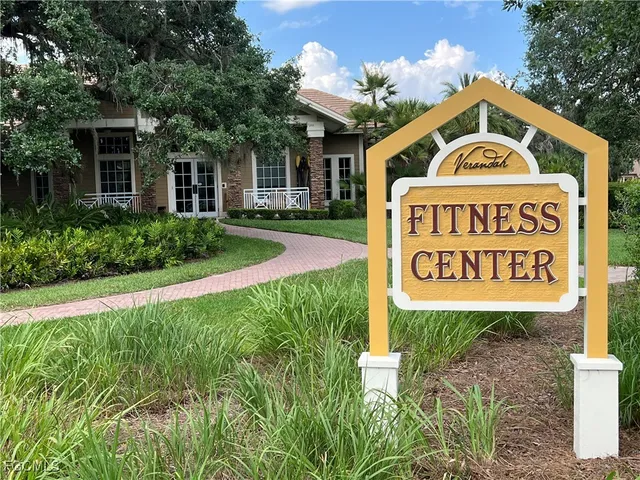 a backyard of a house with barbeque oven and outdoor seating