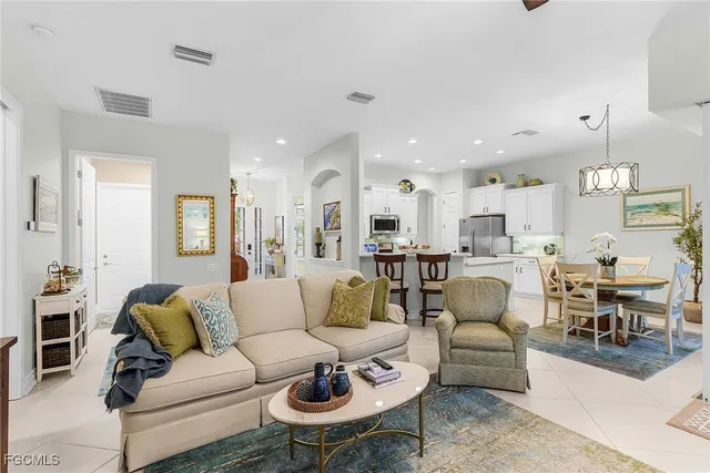 a living room with furniture kitchen view and a dining table