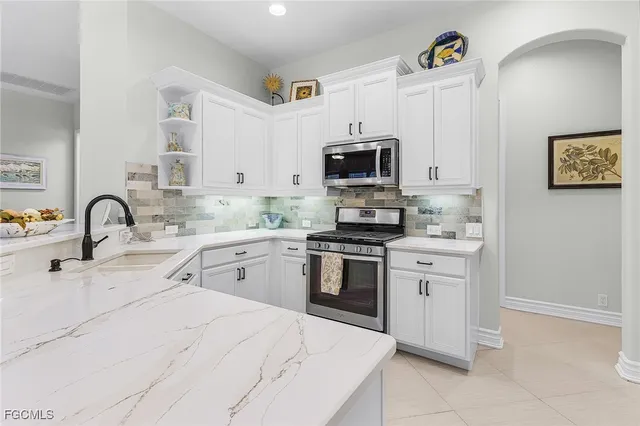 a kitchen with refrigerator cabinets and furniture