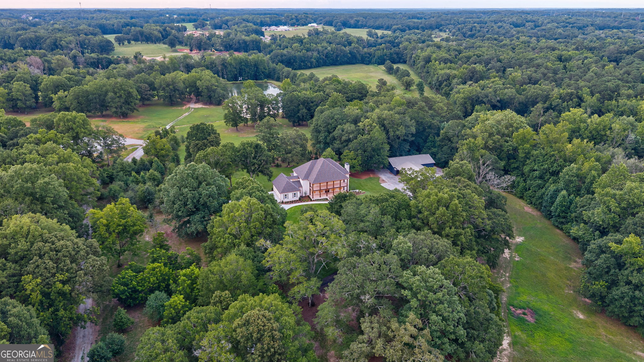 1321 Garrett Road Statham, GA 30666 - Photo 150 of 161 an aerial view of green landscape with trees houses and mountain view