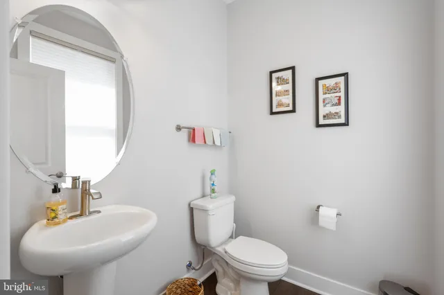 a bathroom with a toilet sink and mirror