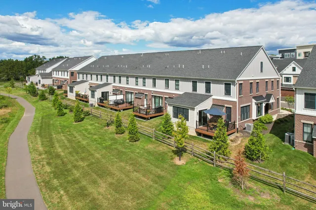 a aerial view of a house with swimming pool lawn chairs and fire pit