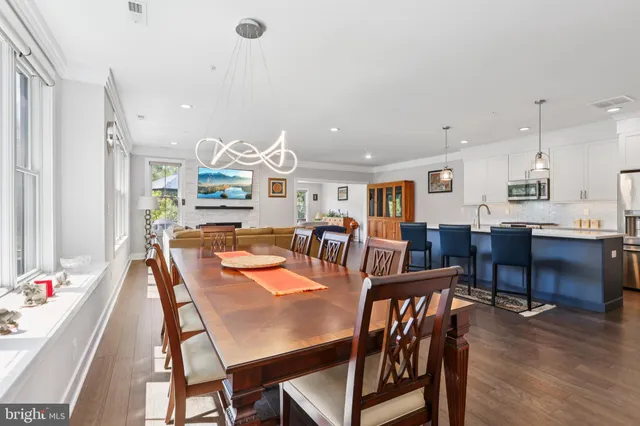 a dining room with furniture and wooden floor