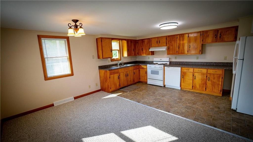 138 Shannon Road Renfrew, PA 16053 - Photo 17 of 25 a kitchen with stainless steel appliances granite countertop a stove a sink and a refrigerator