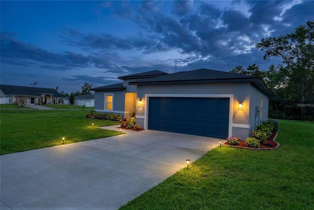 2673 Southwest 156th Place Ocala, FL 34473 - Photo 1 of 14 a view of a house with backyard and garden