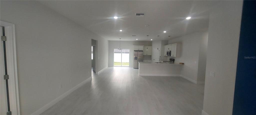 2673 Southwest 156th Place Ocala, FL 34473 - Photo 5 of 14 a view of a big room with wooden floor and windows