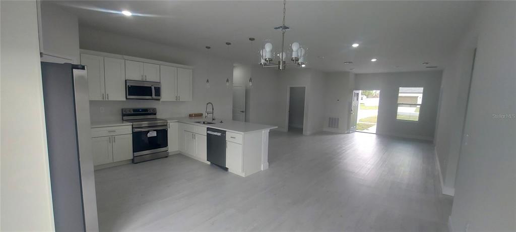 2673 Southwest 156th Place Ocala, FL 34473 - Photo 6 of 14 a view of a kitchen with a sink and a large window
