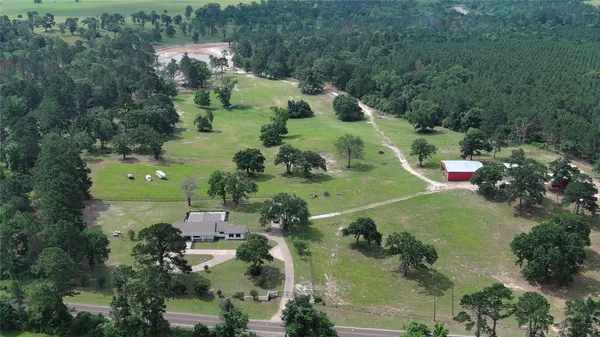an aerial view of a house with a yard
