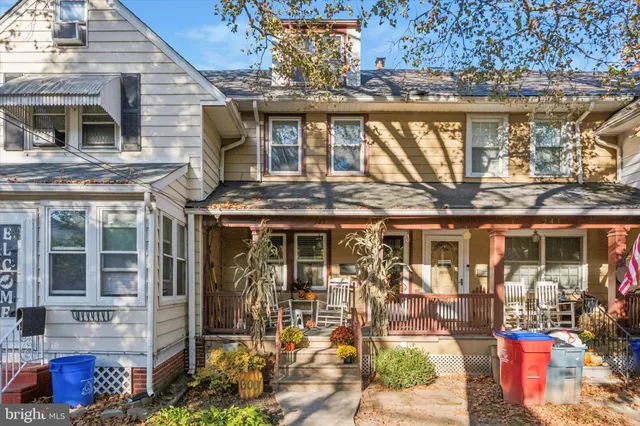 a front view of a building with outdoor seating