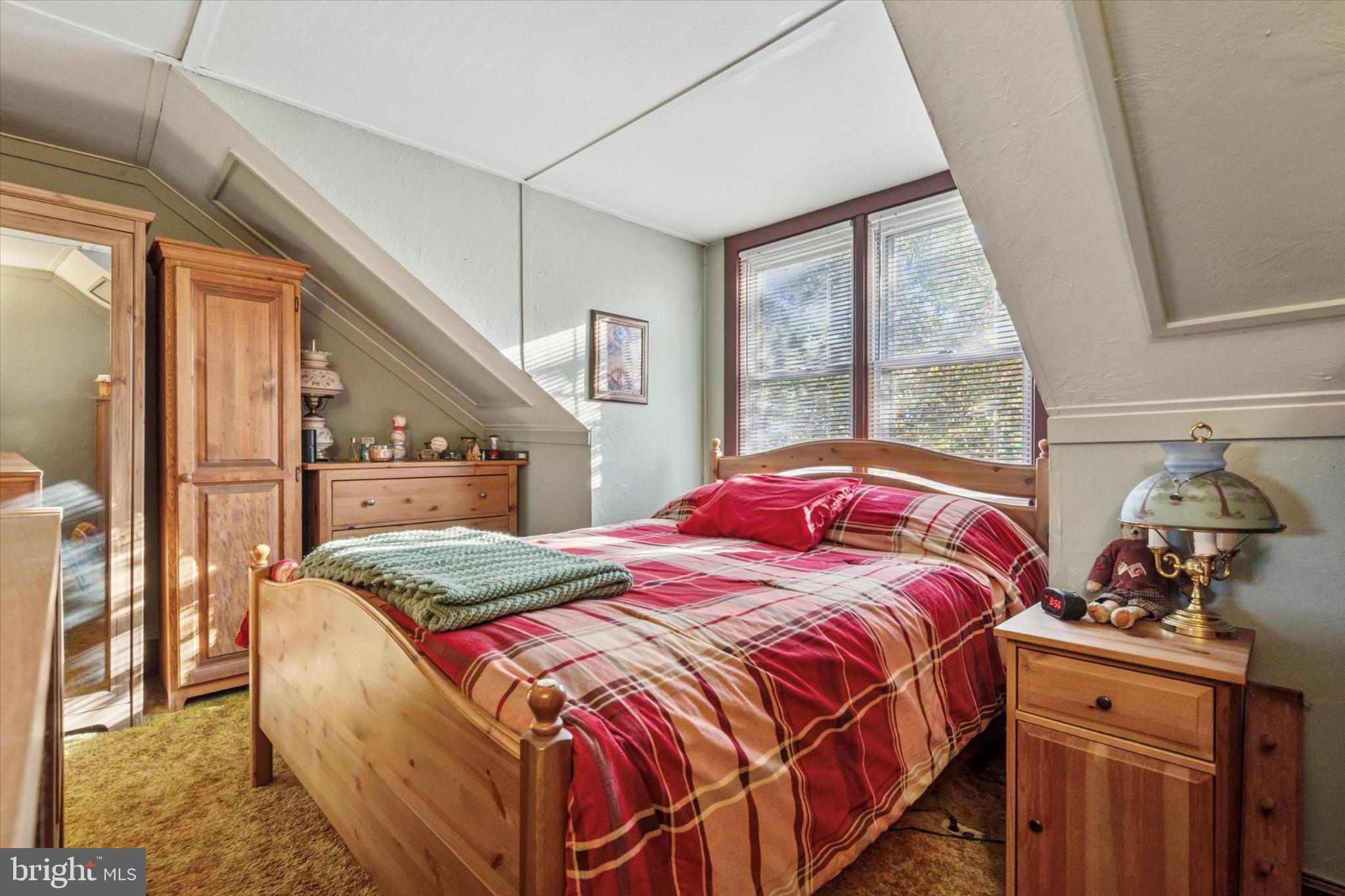 243 Monroe Street Bristol, PA 19007 - Photo 12 of 15 a bedroom with a bed and a dresser next to a window