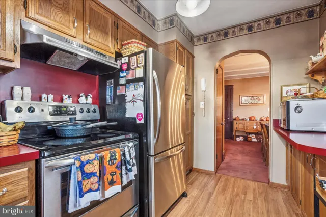 a kitchen with stainless steel appliances granite countertop a stove and cabinets