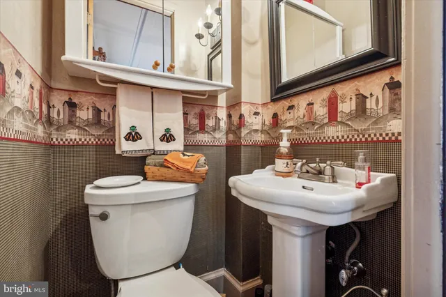 a bathroom with a toilet sink and mirror