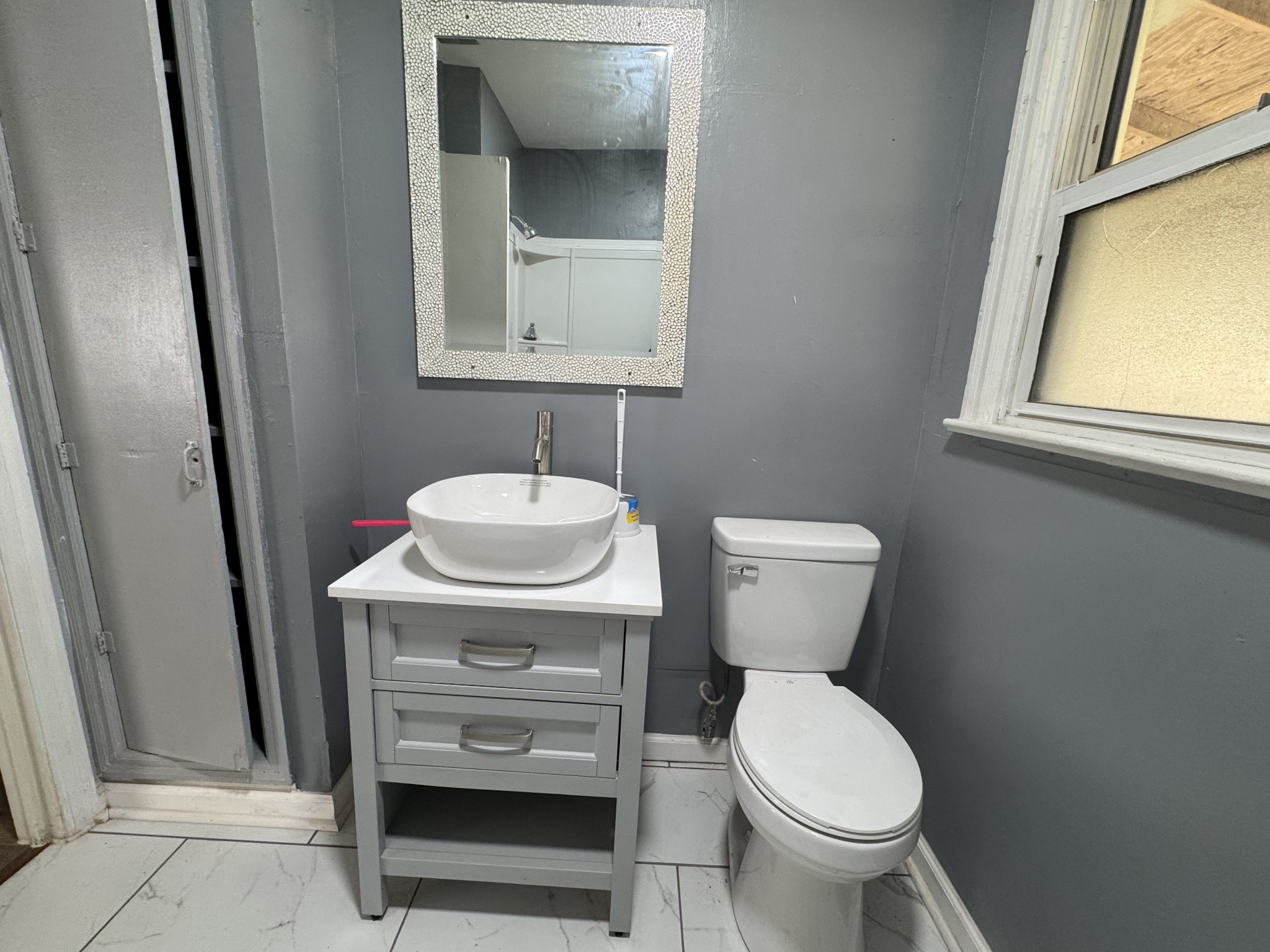 402 East Locust Street Princeton, KY 42445 - Photo 11 of 32 a bathroom with a toilet sink and mirror