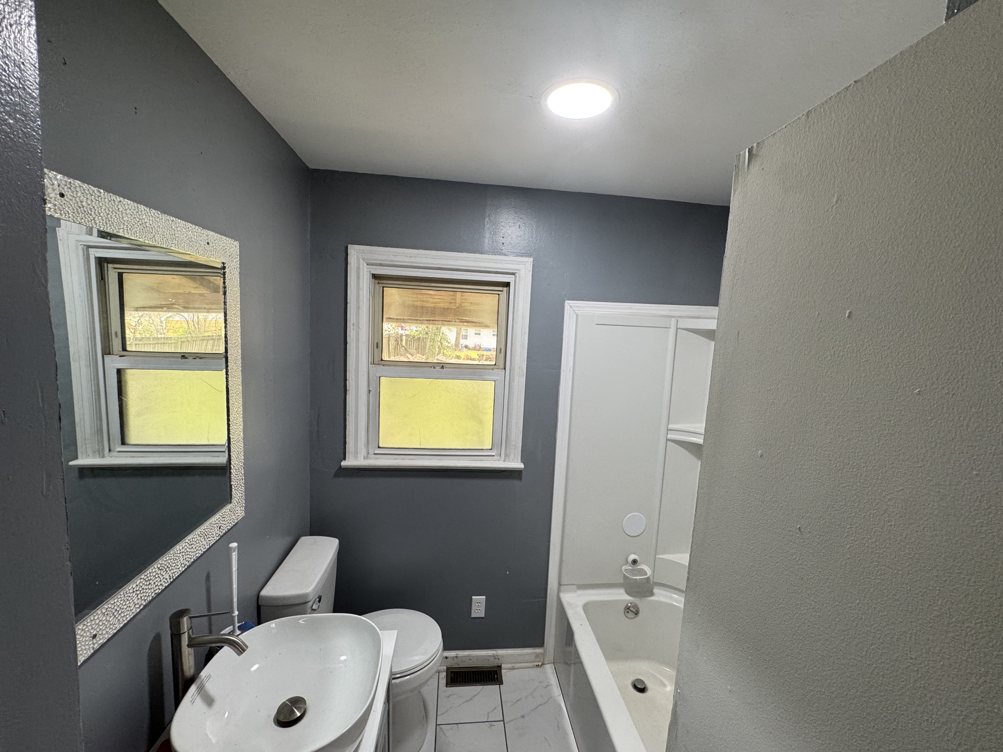 402 East Locust Street Princeton, KY 42445 - Photo 13 of 32 a bathroom with a sink a toilet and a window