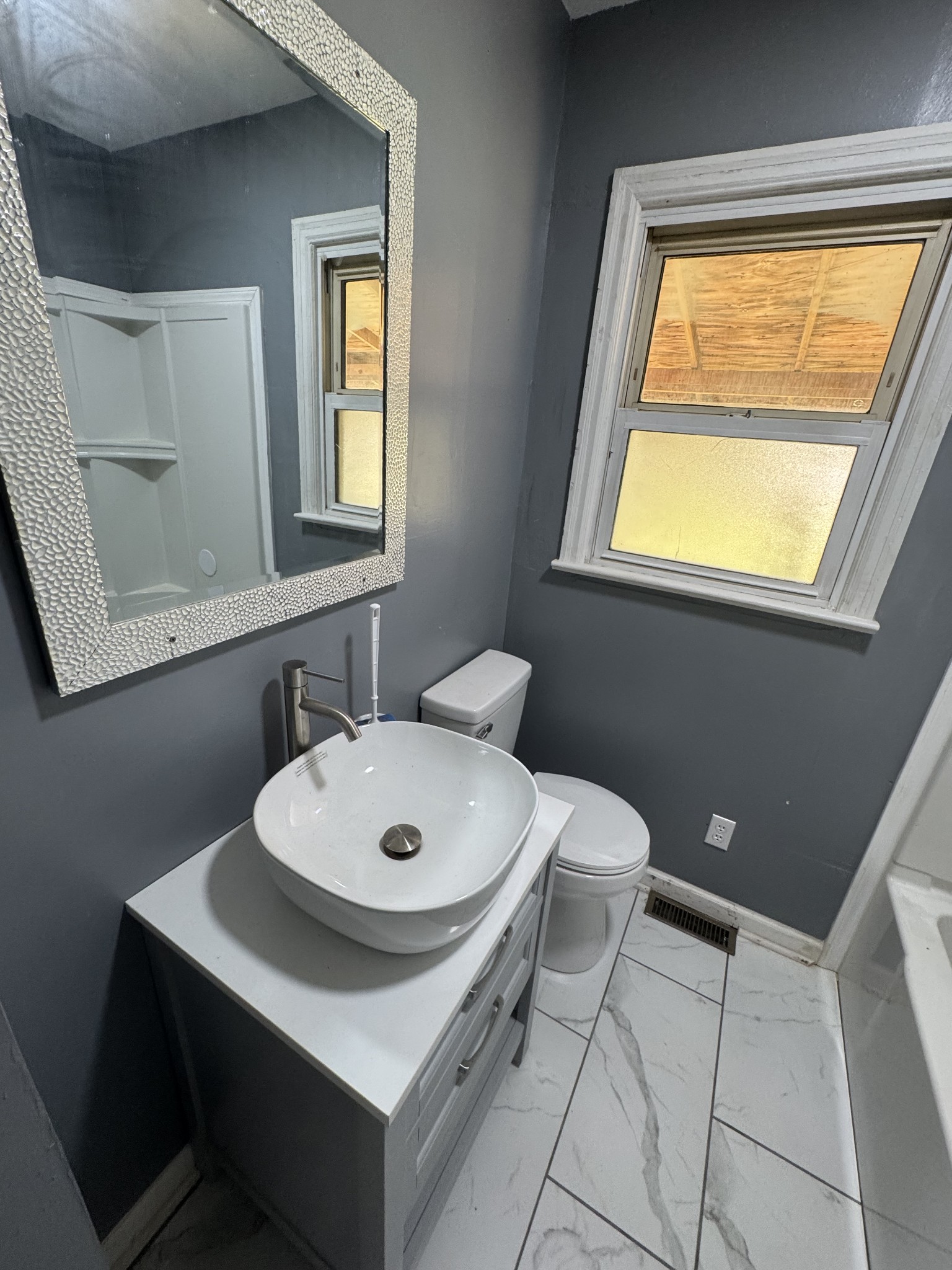402 East Locust Street Princeton, KY 42445 - Photo 15 of 32 a bathroom with a sink a toilet and mirror