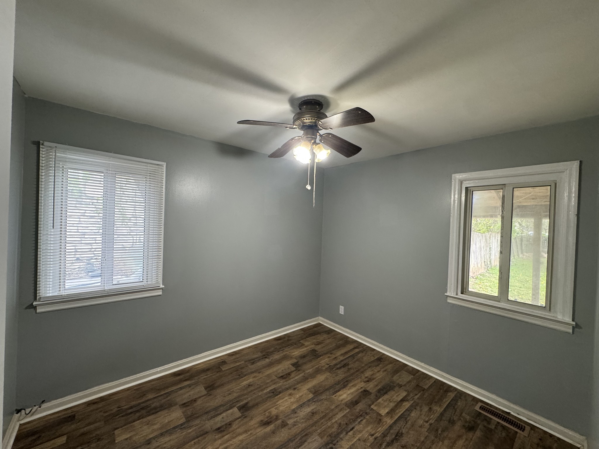402 East Locust Street Princeton, KY 42445 - Photo 17 of 32 a view of an empty room with a window and wooden floor