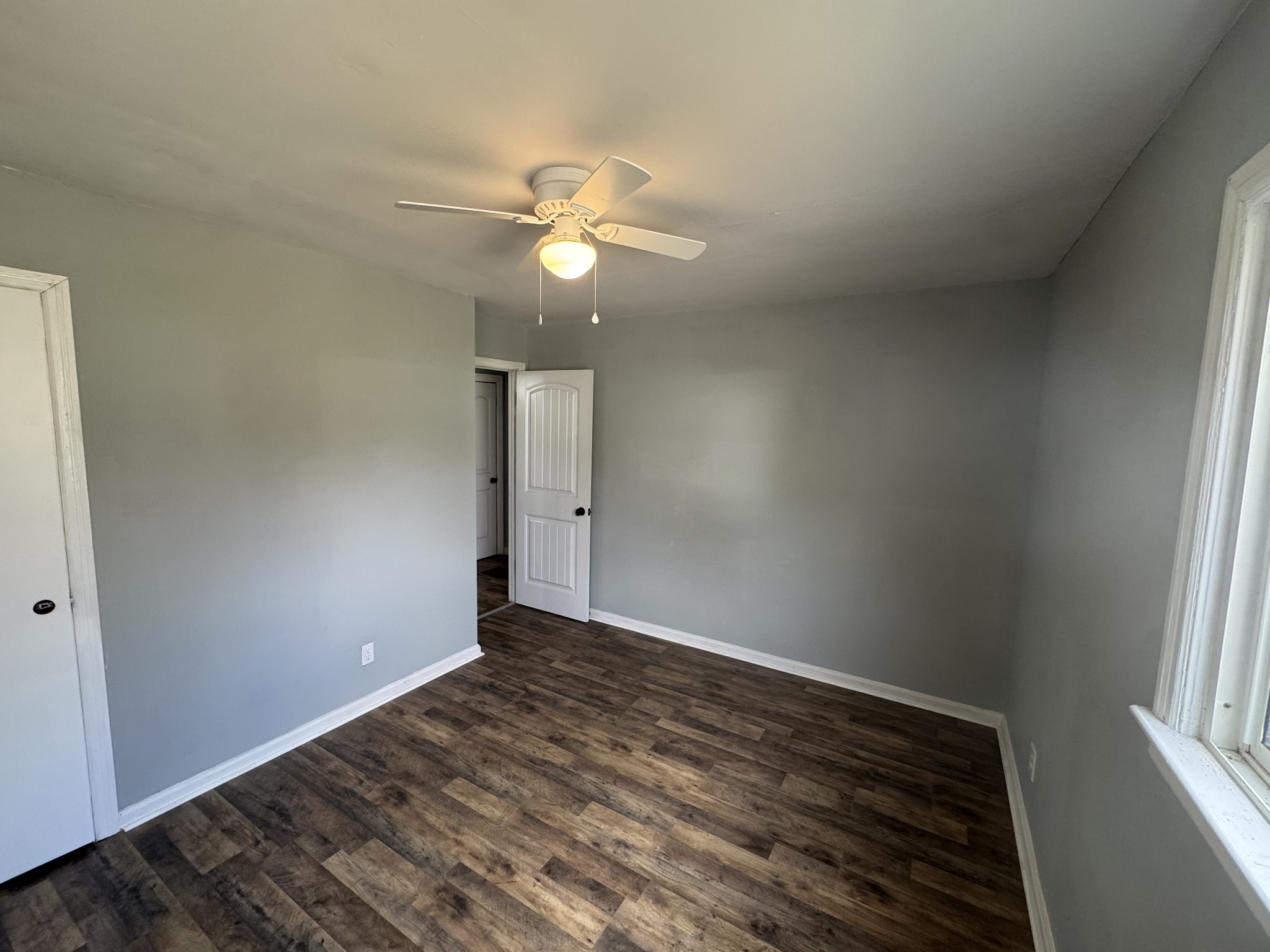 402 East Locust Street Princeton, KY 42445 - Photo 23 of 32 an empty room with wooden floor fan and windows