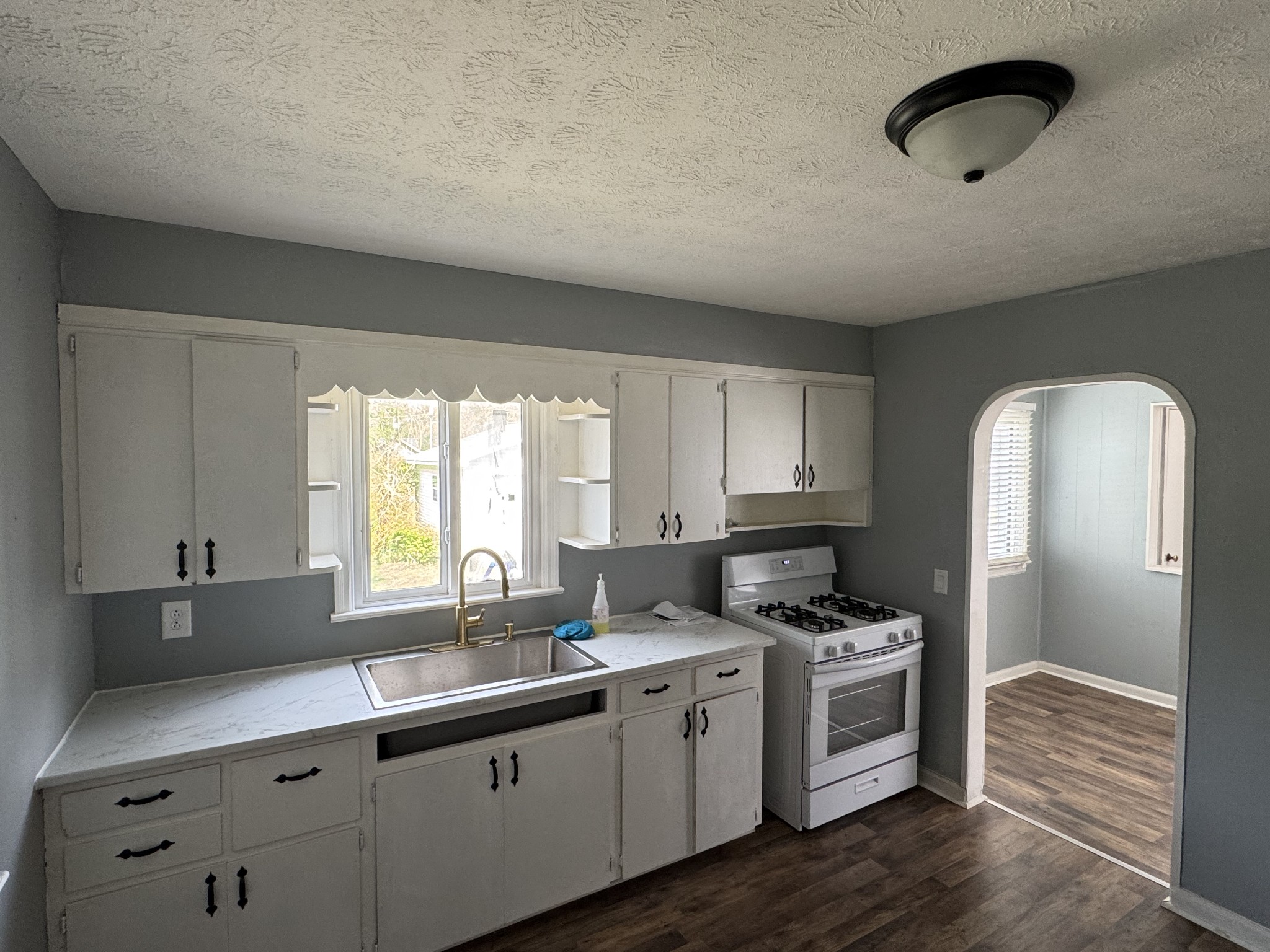 402 East Locust Street Princeton, KY 42445 - Photo 26 of 32 a kitchen with granite countertop a sink cabinets and window