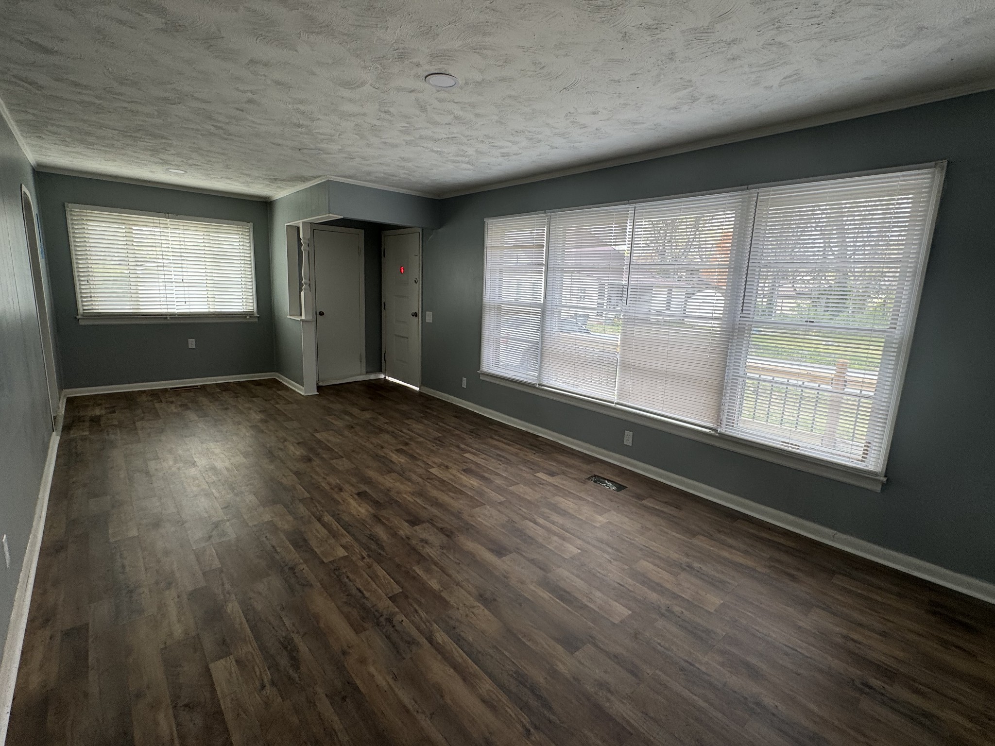 402 East Locust Street Princeton, KY 42445 - Photo 5 of 32 an empty room with wooden floor and windows