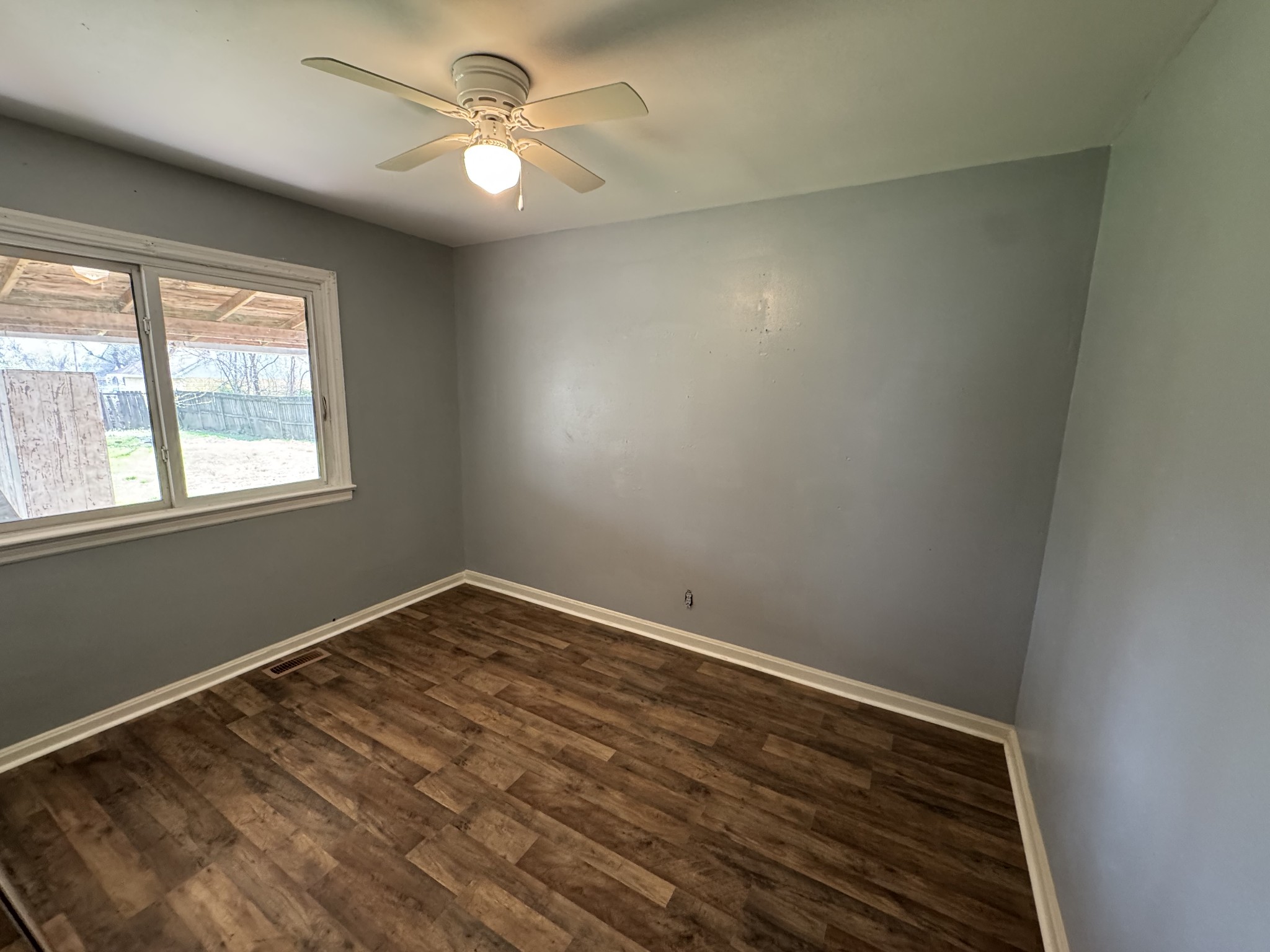 402 East Locust Street Princeton, KY 42445 - Photo 7 of 32 an empty room with a window and a fan
