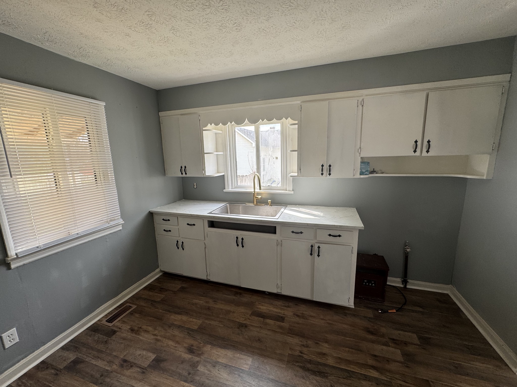 402 East Locust Street Princeton, KY 42445 - Photo 8 of 32 a view of a kitchen with wooden floor and electronic appliances