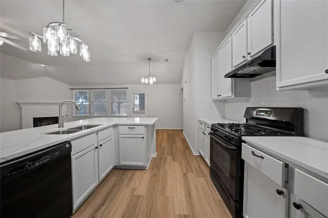a kitchen with stainless steel appliances a stove sink and cabinets