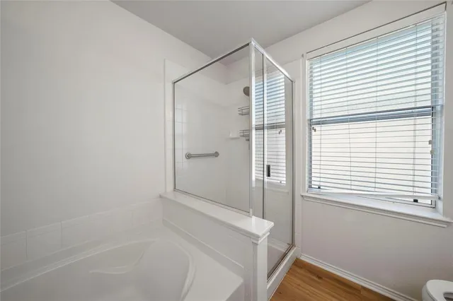 a bathroom with a bathtub and a shower