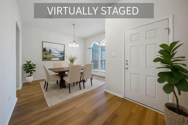 a view of a dining room with furniture and a potted plant