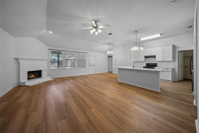 a view of a kitchen with a sink and a fireplace