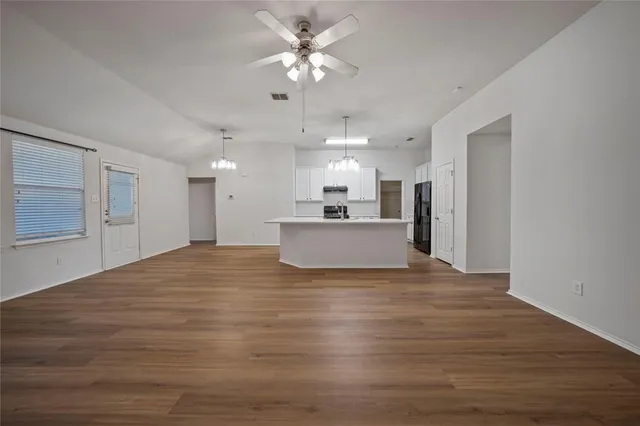 a view of a kitchen with a sink and a refrigerator