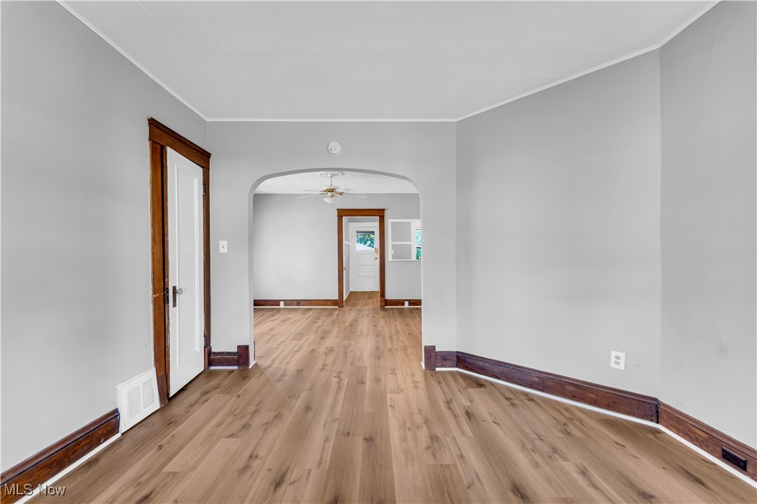 4408 Alpha Avenue Cleveland, OH 44105 - Photo 21 of 41 Unfurnished room featuring ceiling fan, light wood-type flooring, and ornamental molding