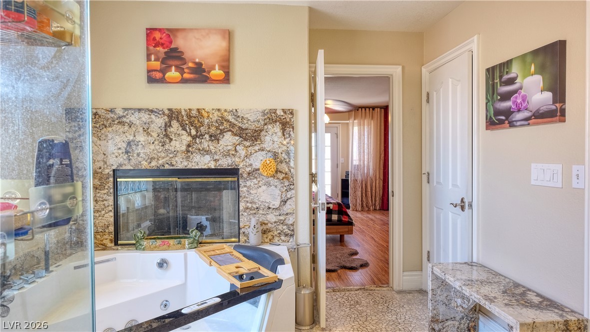 3704 North Campbell Road Las Vegas, NV 89129 - Photo 33 of 38 Indulge in a tranquil spa bath, complete with a fireplace, promising ultimate relaxation.