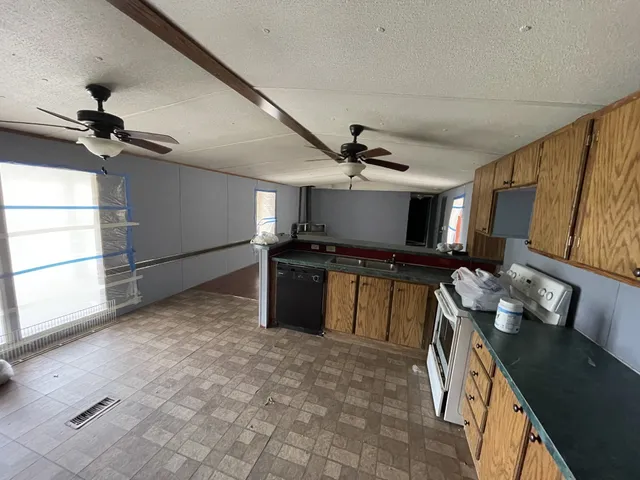 a kitchen with stainless steel appliances granite countertop a stove and a sink