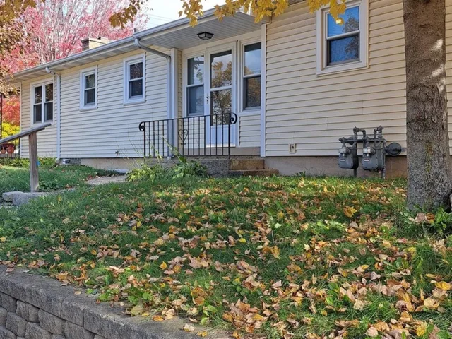 a view of a house with a backyard