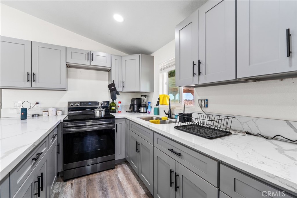 11772-11772 Middleton Road Phelan, CA 92371 - Photo 11 of 40 a kitchen with a sink stove and cabinets