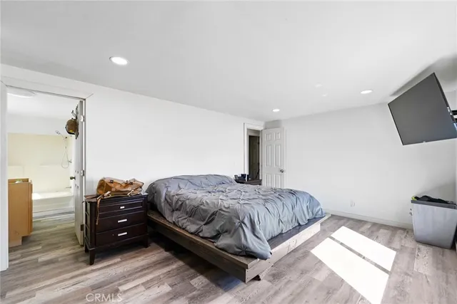 a bedroom with a bed and a television