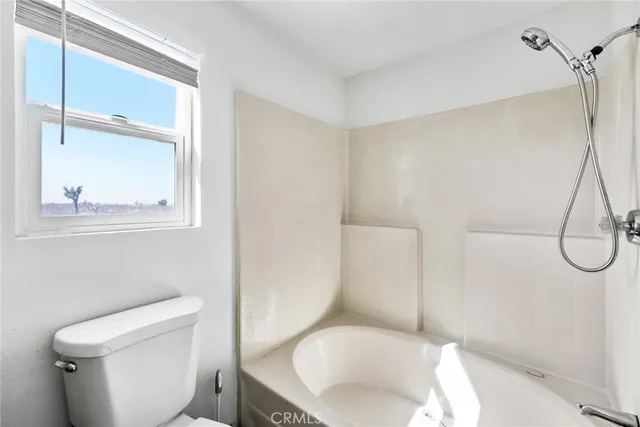 a white toilet sitting next to a bathroom sink