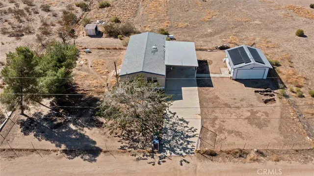 an aerial view of a house with a yard and trees