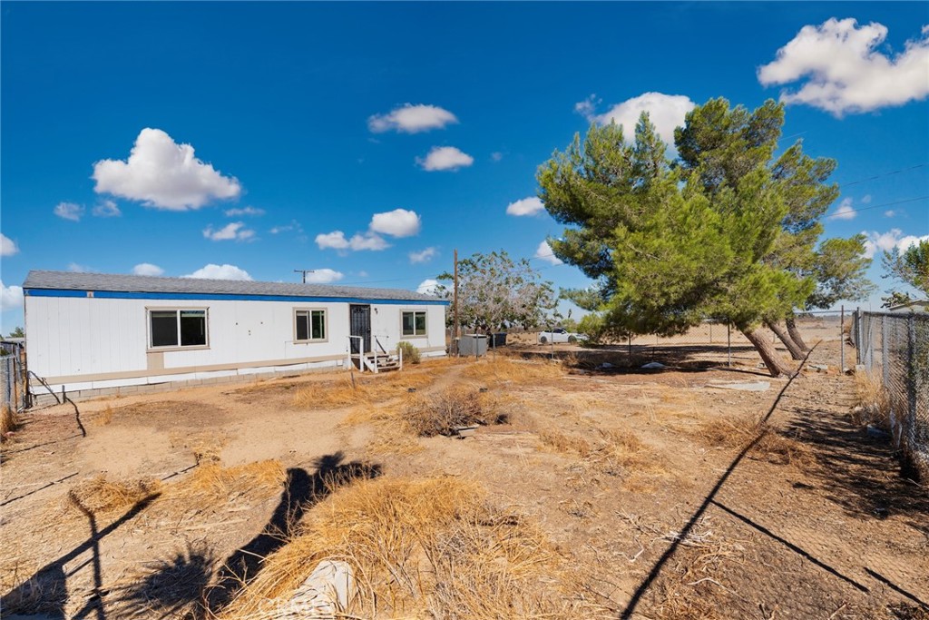 11772-11772 Middleton Road Phelan, CA 92371 - Photo 33 of 40 a view of a house with a yard