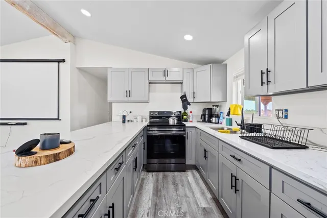 a kitchen with a sink stove and cabinets