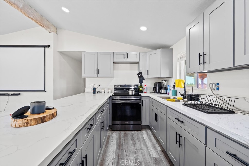 11772-11772 Middleton Road Phelan, CA 92371 - Photo 10 of 40 a kitchen with a sink stove and cabinets