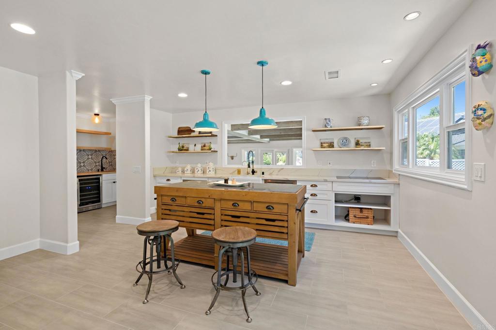 18 Gateview Drive Fallbrook, CA 92028 - Photo 9 of 73 a kitchen with kitchen island a stove a table and chairs in it