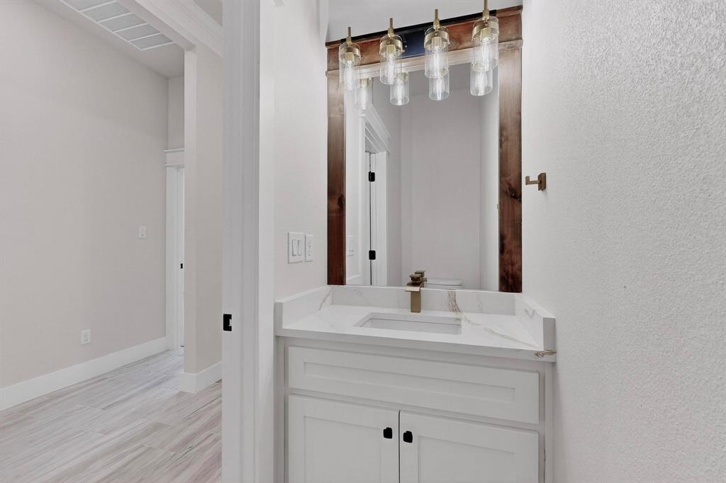 1161 Gonzollas Road Springtown, TX 76082 - Photo 23 of 40 a bathroom with a sink and a mirror