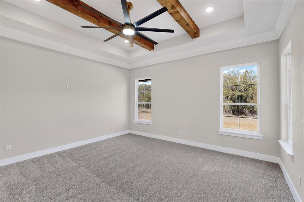 1161 Gonzollas Road Springtown, TX 76082 - Photo 25 of 40 an empty room with windows and fan