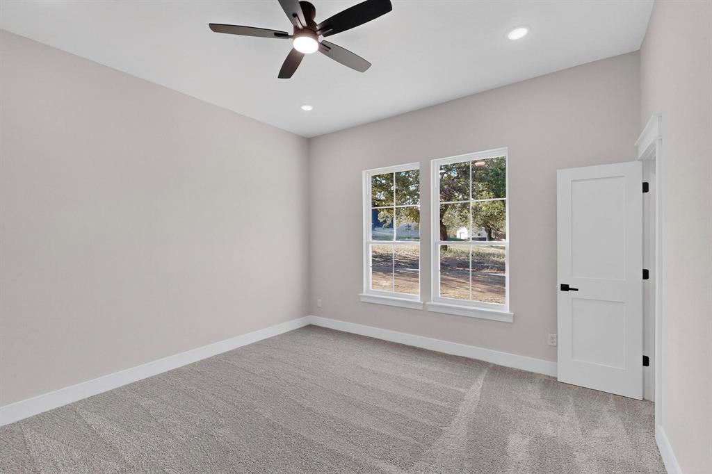 1161 Gonzollas Road Springtown, TX 76082 - Photo 27 of 40 a view of a livingroom with a ceiling fan and window