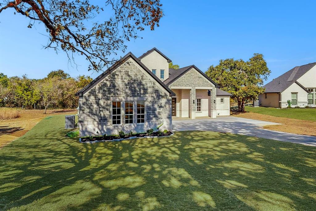 1161 Gonzollas Road Springtown, TX 76082 - Photo 3 of 40 a view of a house with a yard