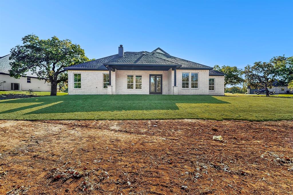 1161 Gonzollas Road Springtown, TX 76082 - Photo 40 of 40 a view of a house with a yard