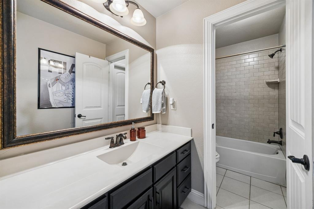 3917 Gatewick Drive Rockwall, TX 75087 - Photo 23 of 34 a bathroom with a bathtub a shower a sink and a mirror