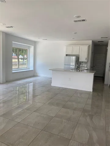 a view of a livingroom with furniture and staircase